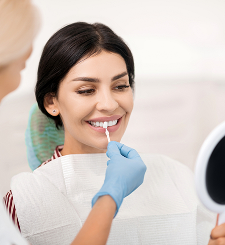 Female patient having teeth shade matched for veneers
