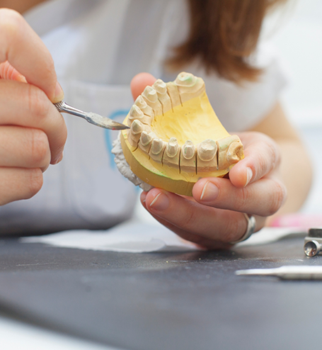 Working on model of teeth