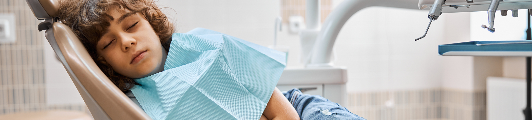 Young patient relaxing in dental chair