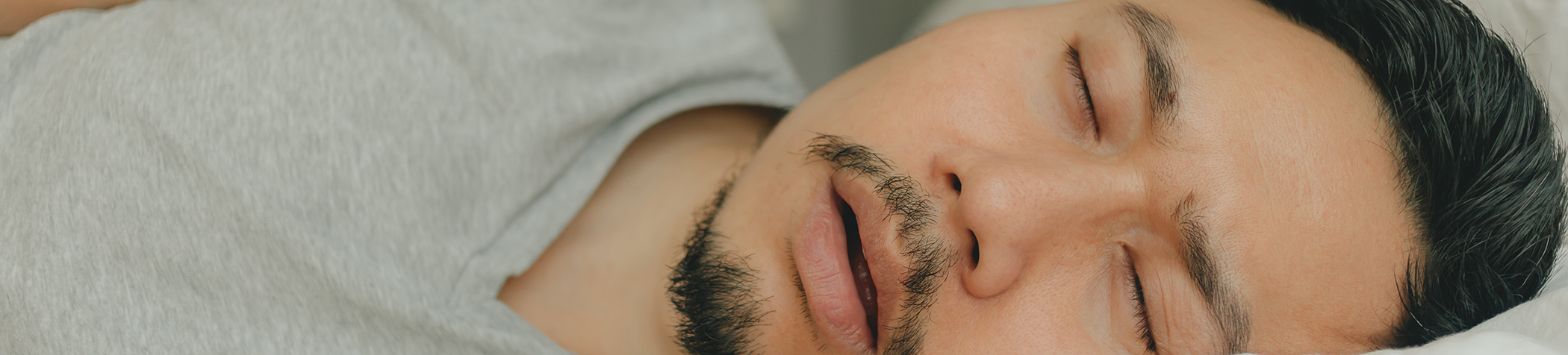 Close up of man with facial hair snoring